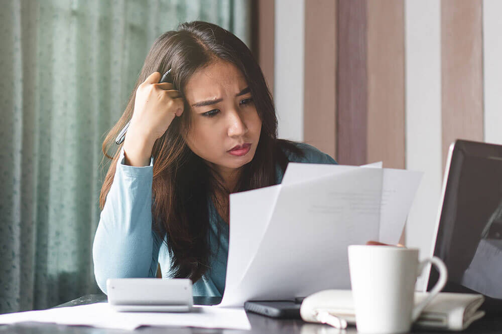 Woman looking at bills