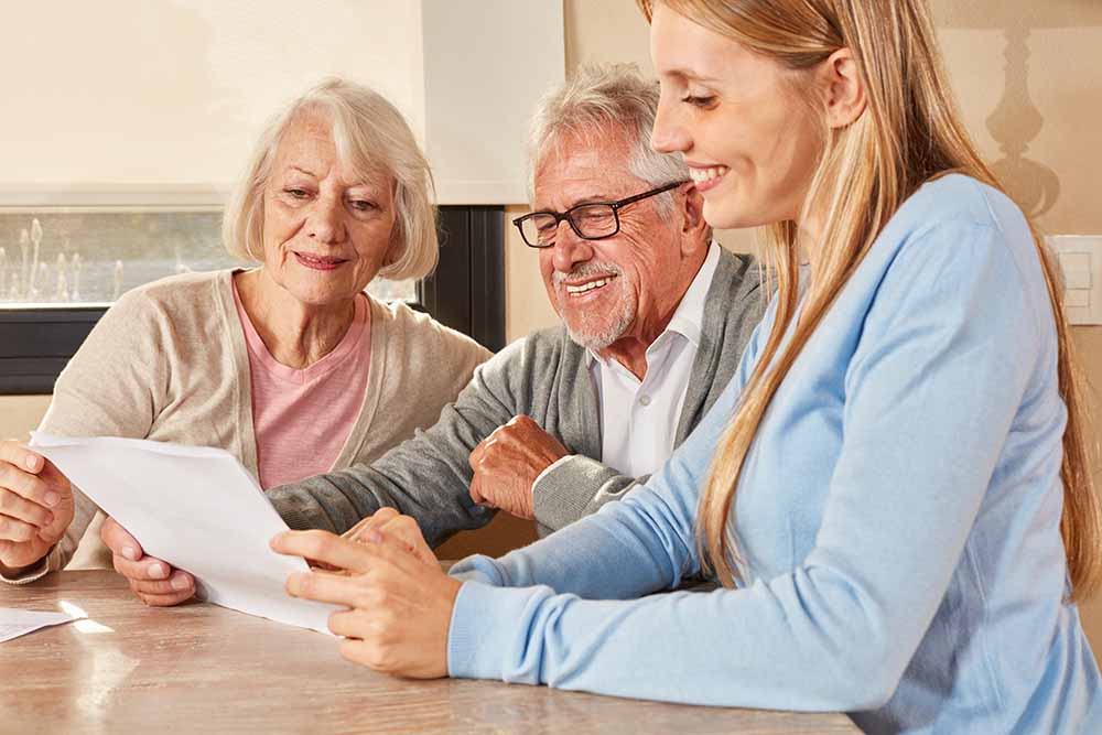 Woman helping her elderly parents with paperwork