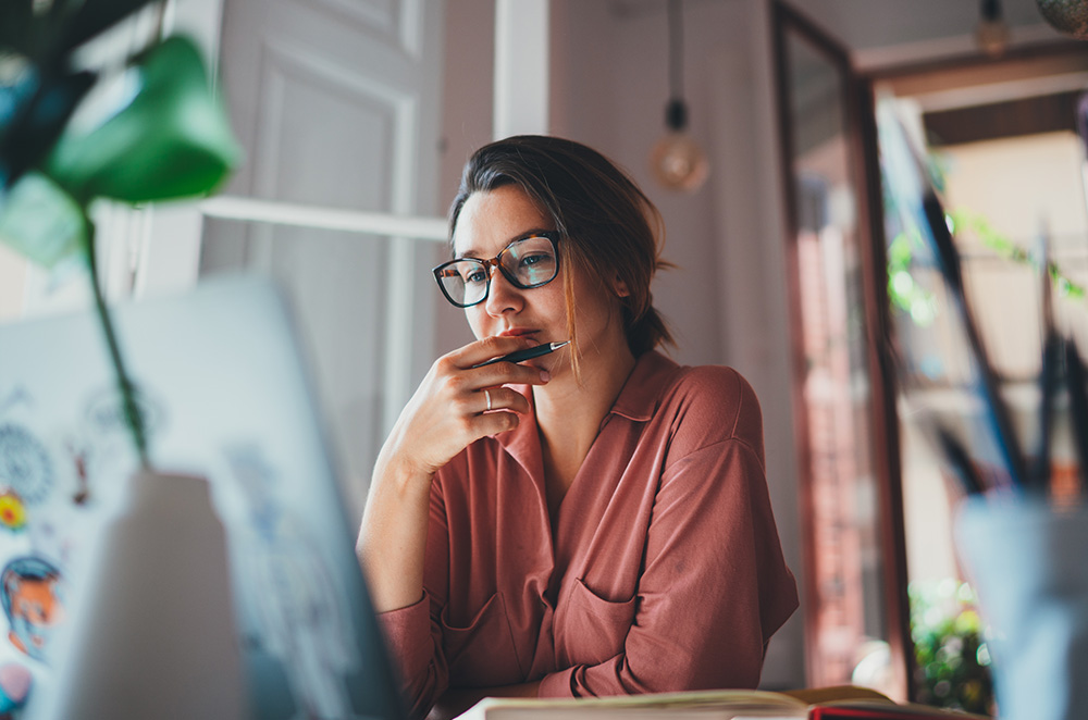 A woman looking at a laptop